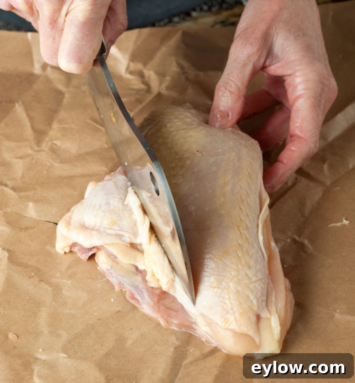 Roast Chicken - Trimming small ribs bones from a raw bone-in chicken breast for better presentation and cooking.