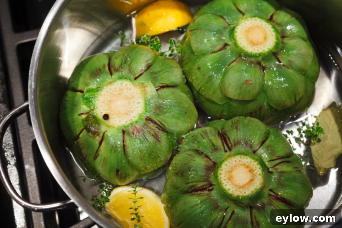 Close-up of vibrant green artichokes steaming in a pan with lemons and herbs