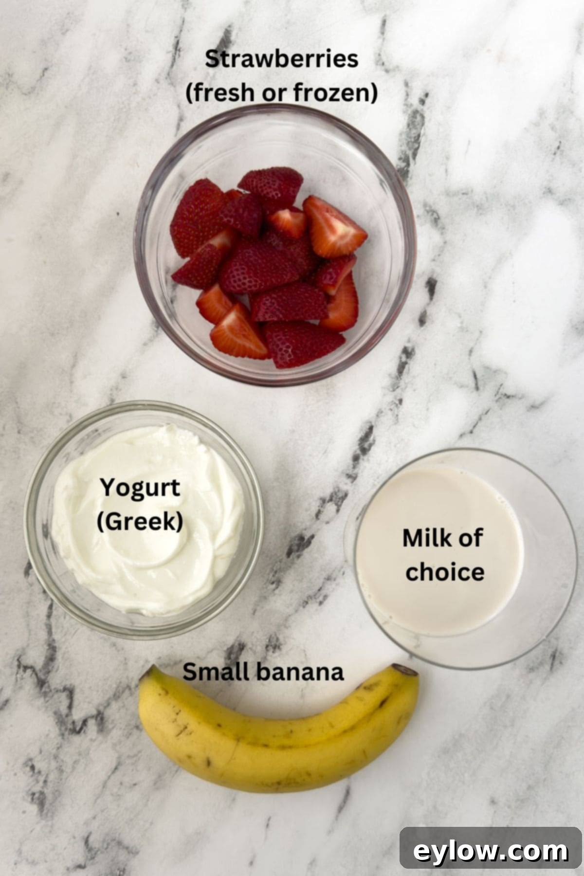 Creamy Strawberry Banana Yogurt Blend 3 Strawberries, banana, milk, and yogurt on the counter for a smoothie.