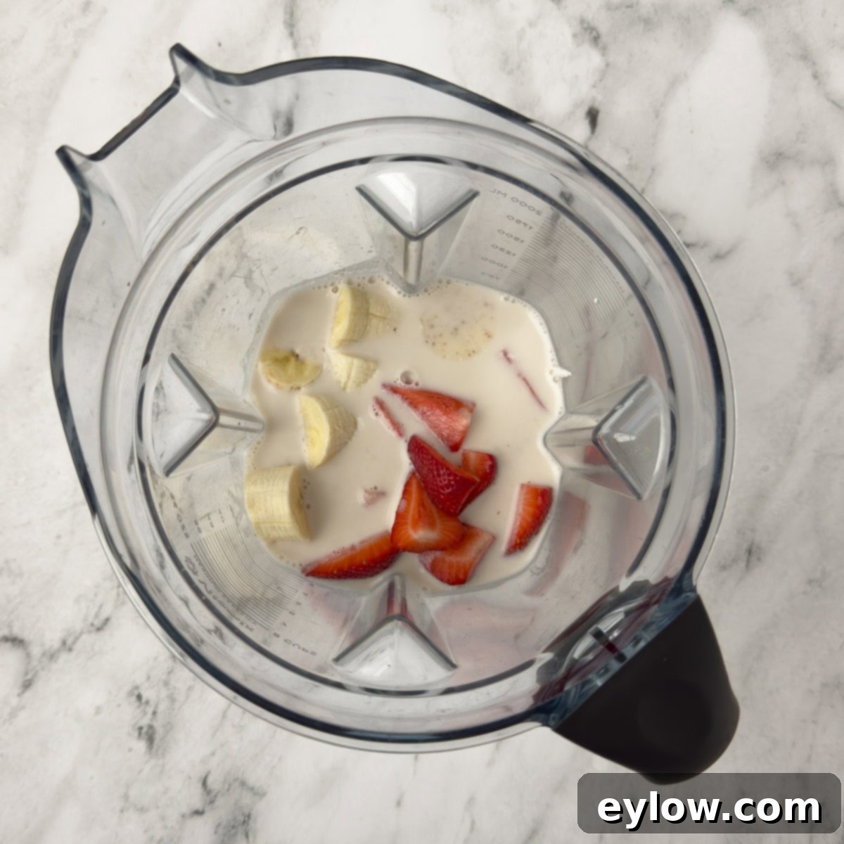 Creamy Strawberry Banana Yogurt Blend 5 Strawberry banana smoothie ingredients in a blender with milk.