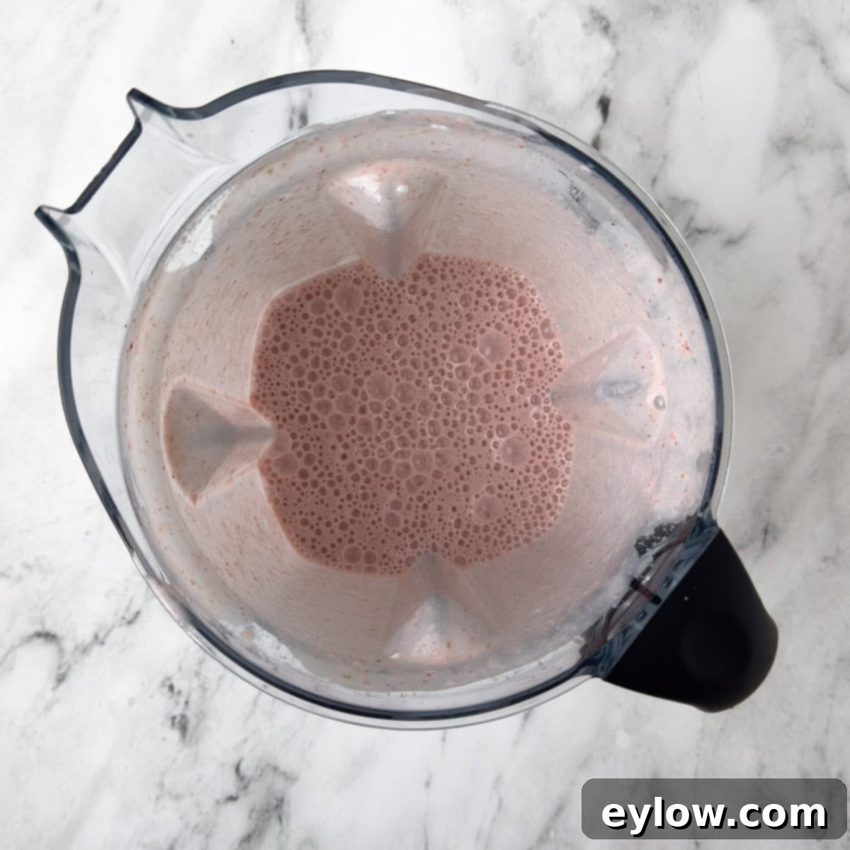 Creamy Strawberry Banana Yogurt Blend 6 Beautiful pink strawberry smoothie with yogurt and bananas ready to drink.