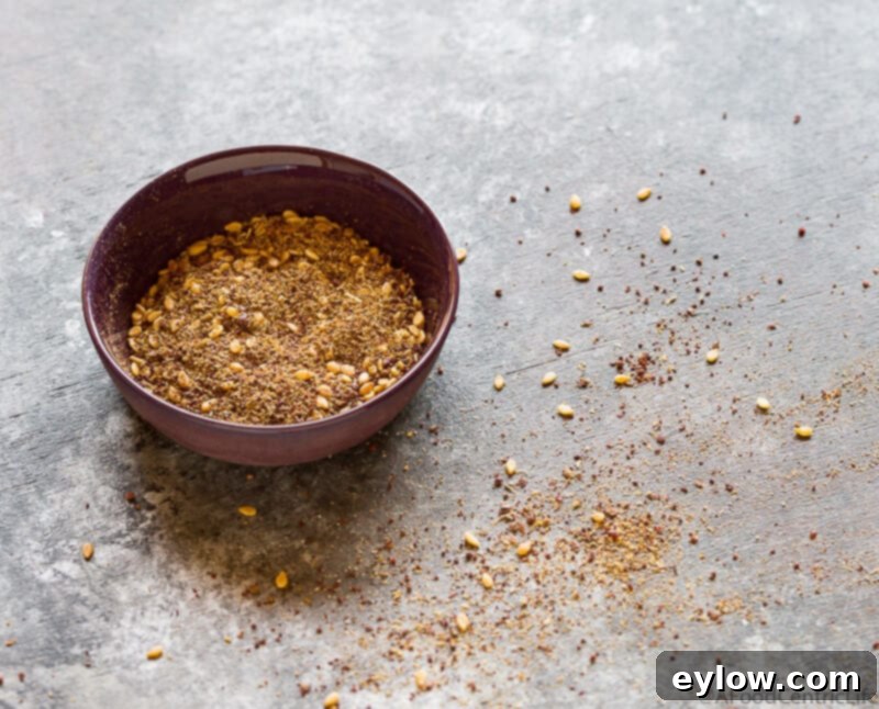 Velvety Homemade Mediterranean Hummus 4 A small bowl of the Middle Eastern spice, za'atar on a gray counter.
