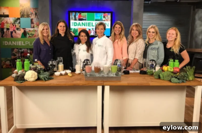 Velvety Homemade Mediterranean Hummus 7 The Daniel Plan video shoot team for a webinar behind a wooden island counter with lots of fresh healthy foods.