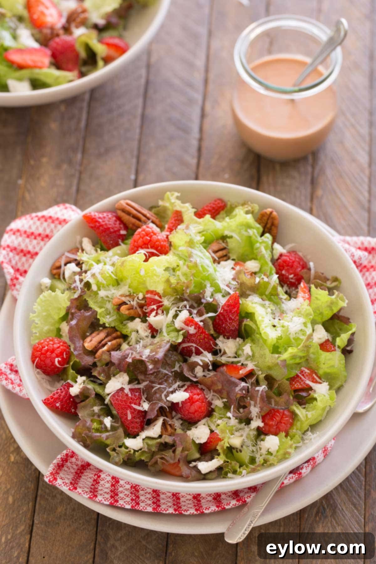 Strawberry goat cheese salad with raspberries, pecan, and strawberry vinaigrette.