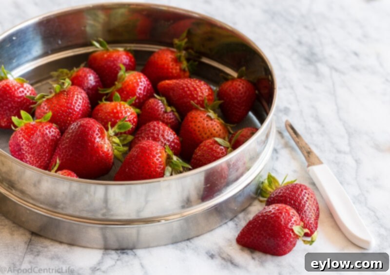 Ripe red strawberries on the counter.