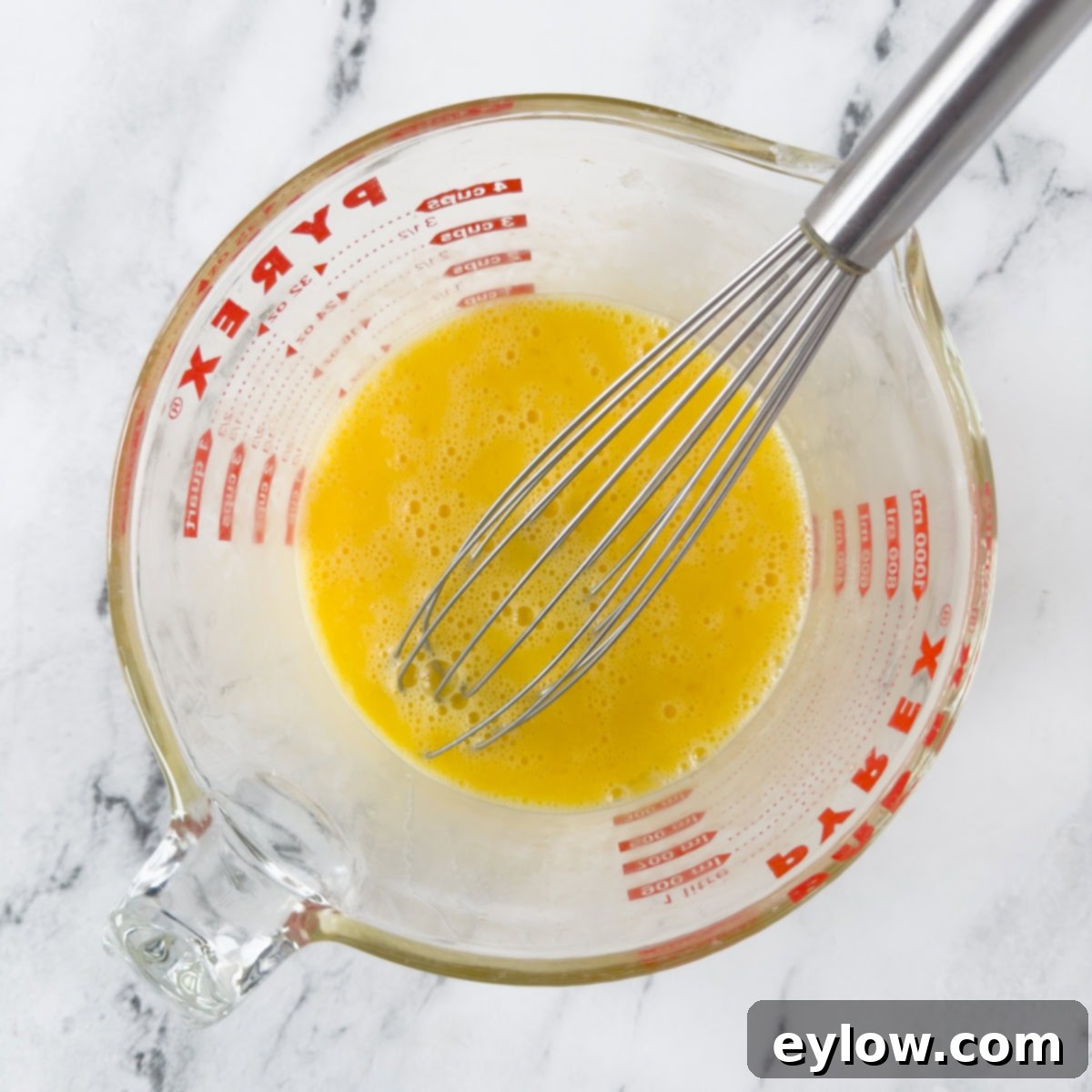 Gluten-Free Dutch Baby German Pancakes 4 Whisking eggs vigorously in a Pyrex measuring cup until they are smooth and slightly frothy.