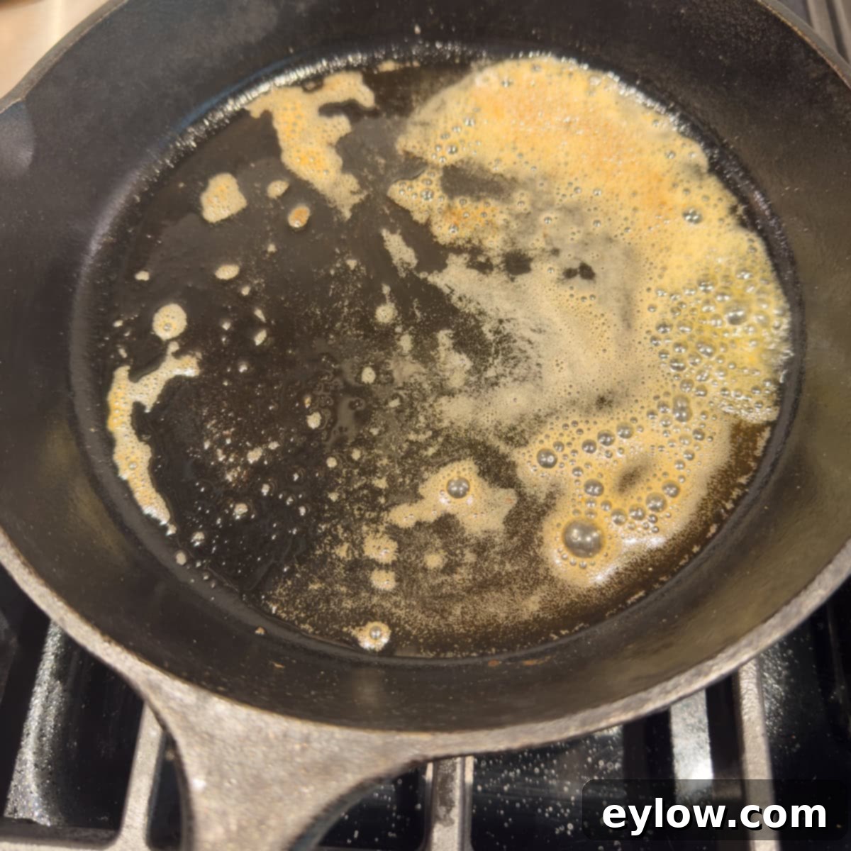 Gluten-Free Dutch Baby German Pancakes 6 Melted and slightly browned butter glistening in a hot black cast iron skillet, ready for the batter.