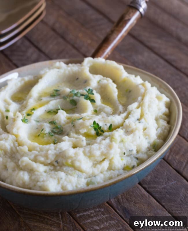 creamy cauliflower puree in a serving bowl on a table | AFoodCentricLife.com