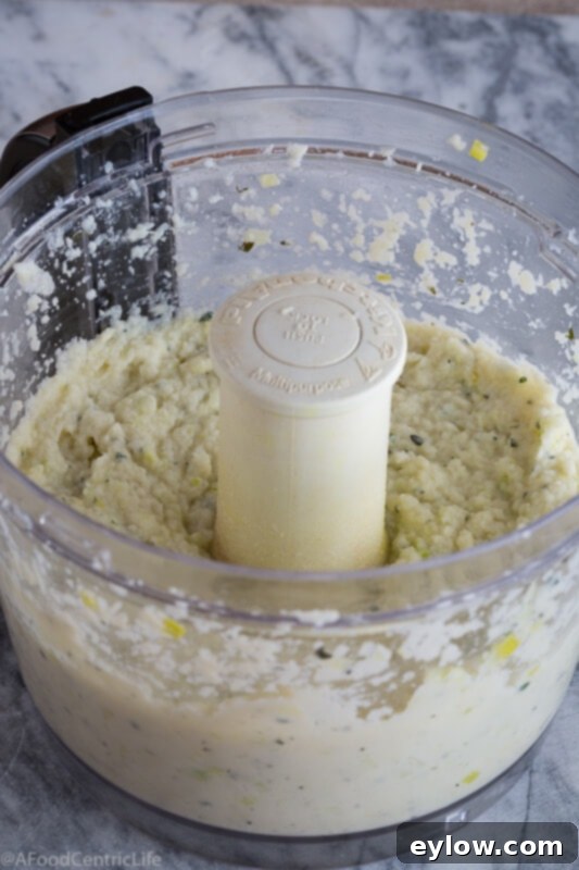 creamy cauliflower puree in food processor bowl | AFoodCentricLife.com