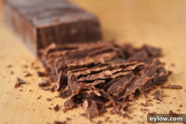 Chopped chocolate on a cutting board.