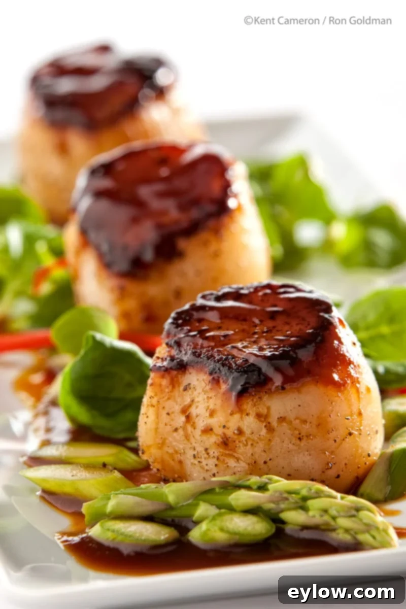 Hoisin-Glazed Golden Scallops 2 Perfectly seared scallops with a glossy Hoisin glaze, ready to serve as a gourmet dinner.