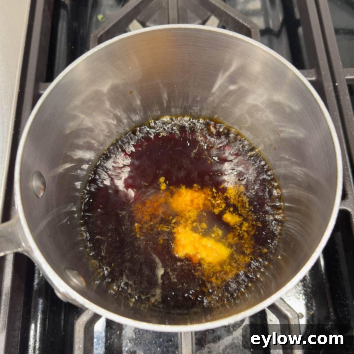 Making teriyaki sauce in a small pan on the stovetop.