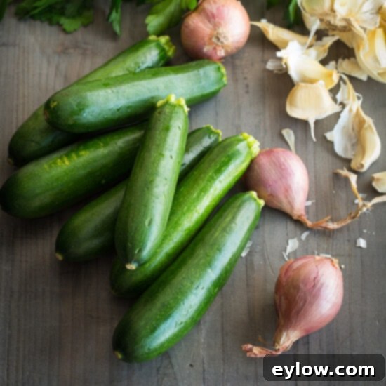 Fresh zucchini on a cutting board with shallots, ready for preparation.