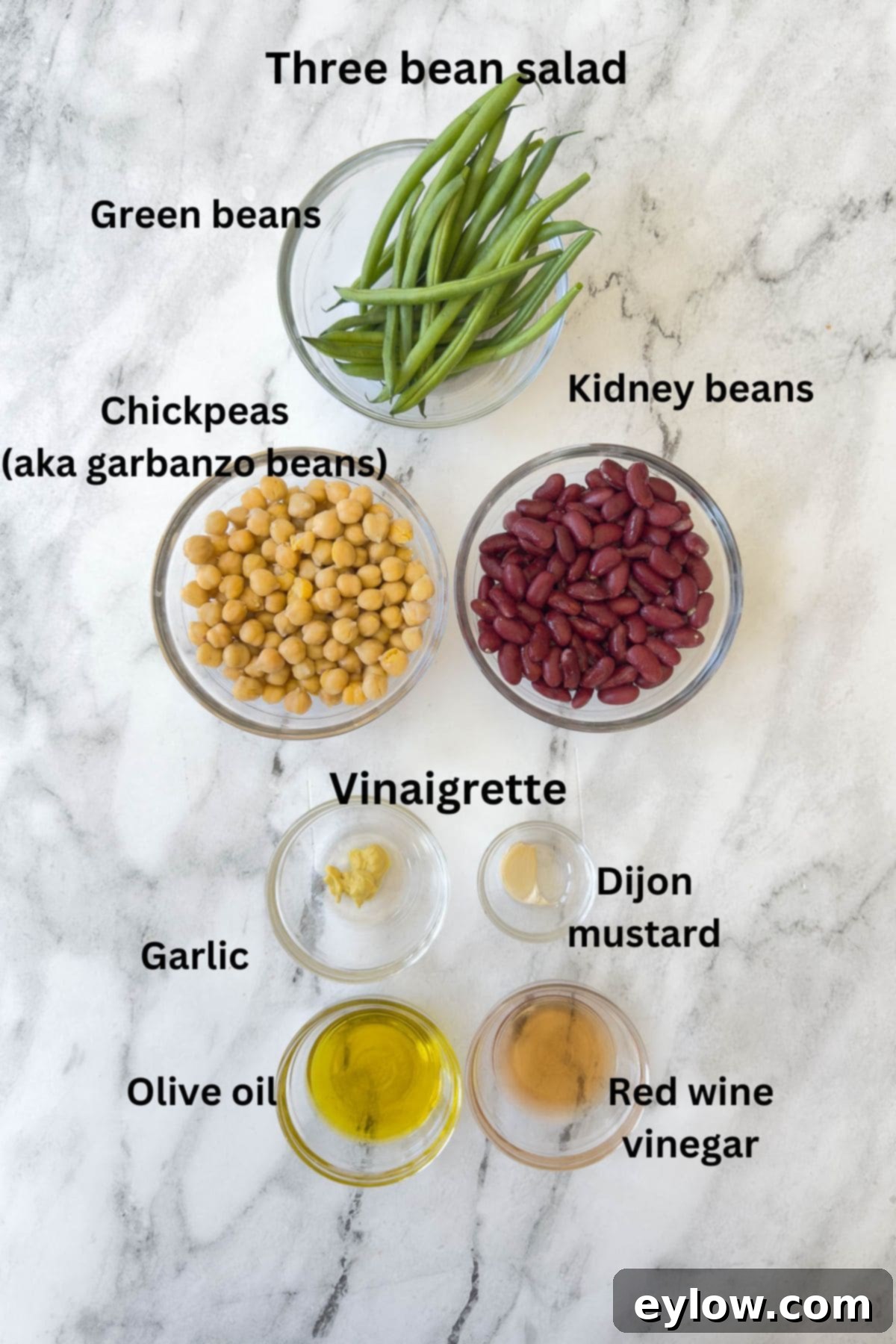 Effortless Zesty Three Bean Salad 4 Ingredients for a three beans salad and vinaigrette on a marble counter.