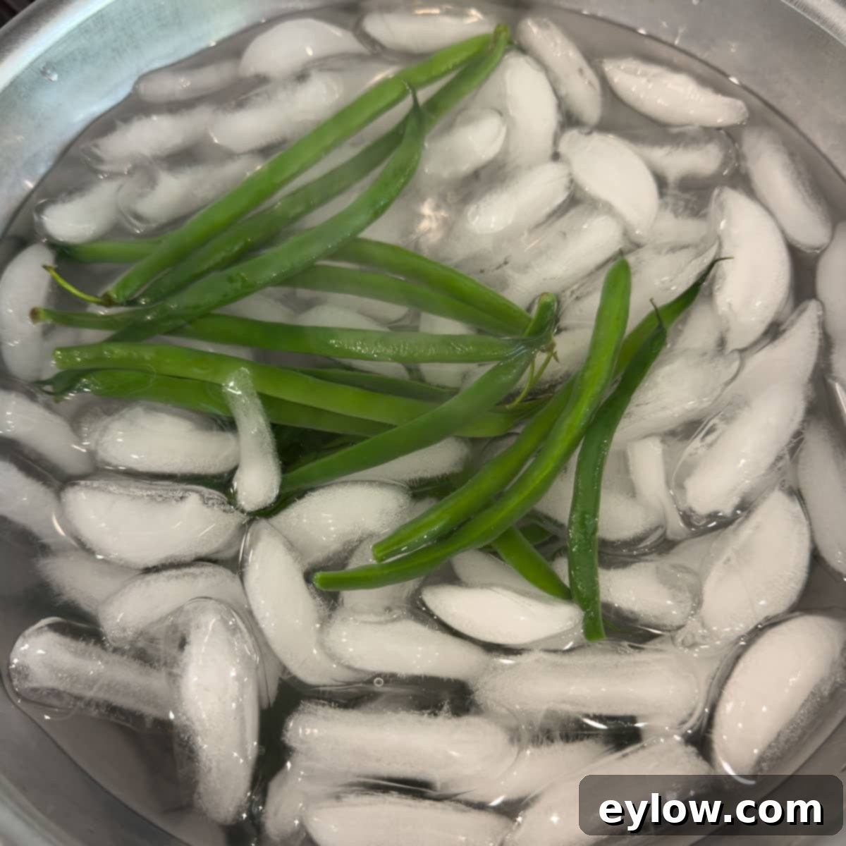 Effortless Zesty Three Bean Salad 6 Cooked green beans in an ice bath chilling.