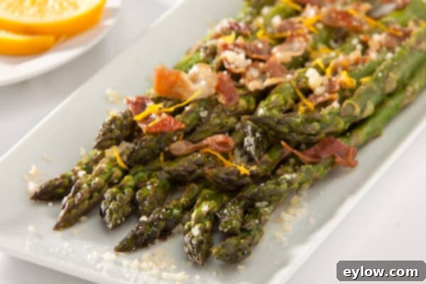 Roast Asparagus garnished with prosciutto, lemon zest, and Parmesan.