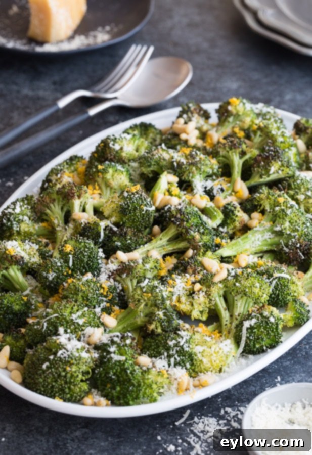 Roasted broccoli with pine nuts and lemon zest on a plate