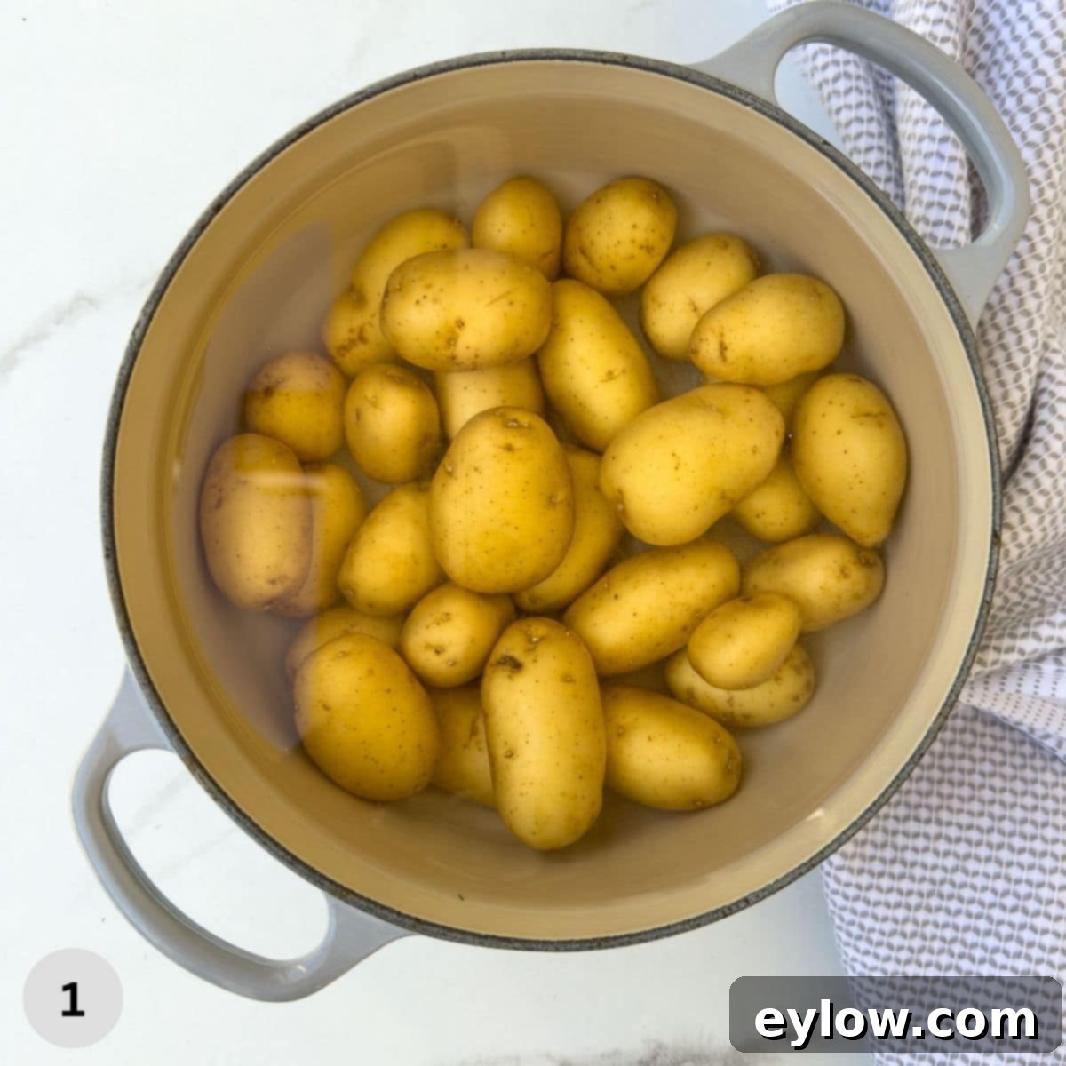 Golden Buttered Potato Gems 4 Cooking baby dutch potatoes in a gray pot.