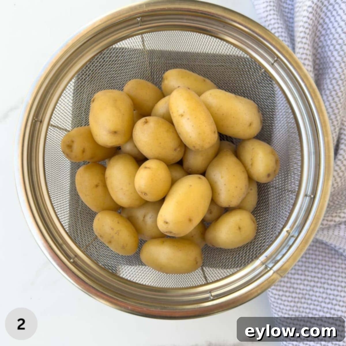Golden Buttered Potato Gems 5 Baby gold potatoes in a colander after cooking.
