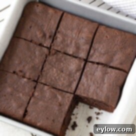 Decadent Fudgy Gluten-Free Chocolate Brownies 13 Gluten-free brownies with melted chocolate in a square pan after baking and cooling, ready to be sliced.