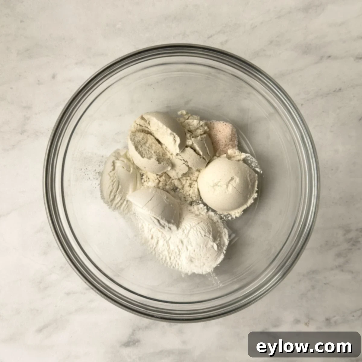 Decadent Fudgy Gluten-Free Chocolate Brownies 4 Dry ingredients for baking brownies, including gluten-free flour, arrowroot starch, baking powder, and salt, whisked together in a glass bowl.