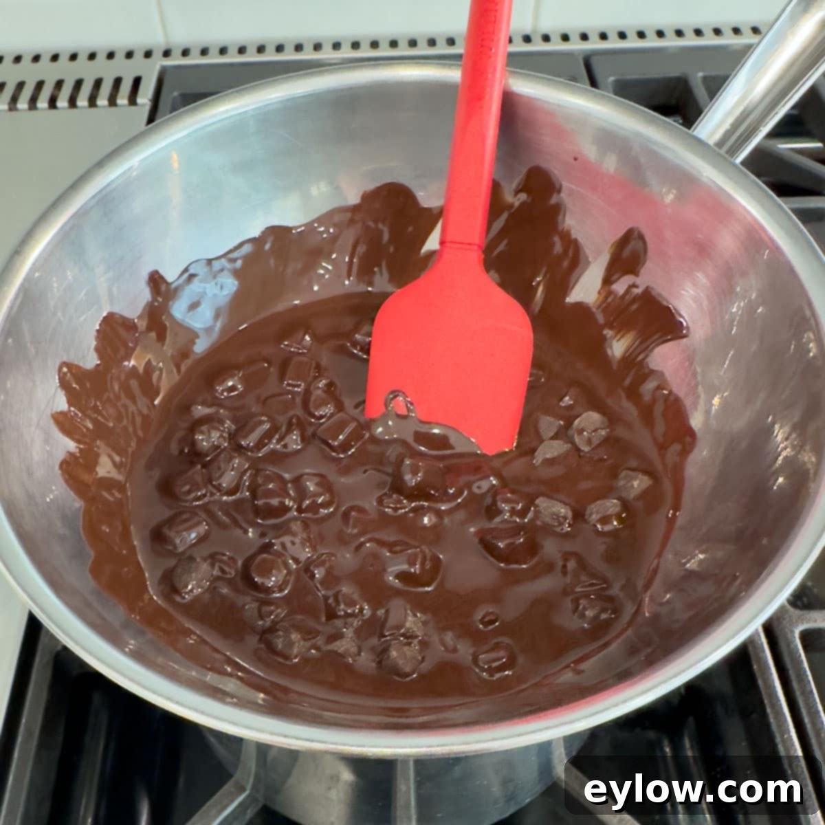 Decadent Fudgy Gluten-Free Chocolate Brownies 5 Melting dark chocolate in a double boiler setup on the stovetop, demonstrating gentle heat application.