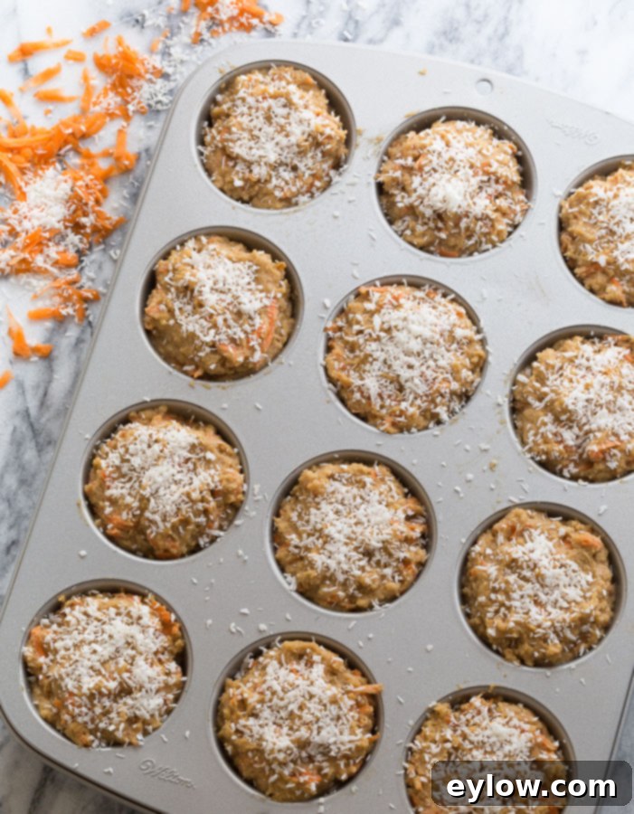 Moist Gluten-Free Dairy-Free Carrot Cake Muffins 3 Close-up of muffin batter being scooped into a silver muffin pan, ready for baking.