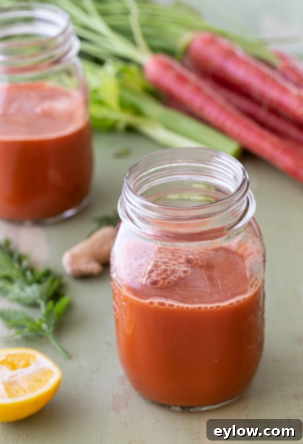 Vibrant orange carrot ginger juice in a glass, ready to be enjoyed as a morning glow drink