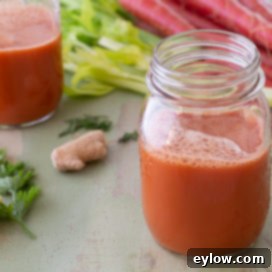 Vibrant carrot ginger juice in a clear glass, ready for a healthy start to the day.