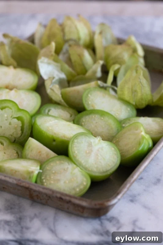 Tomatillo Enchilada Verde 4 Close-up of chopped tomatillos, peppers, and onion in a saucepan, ready for simmering.