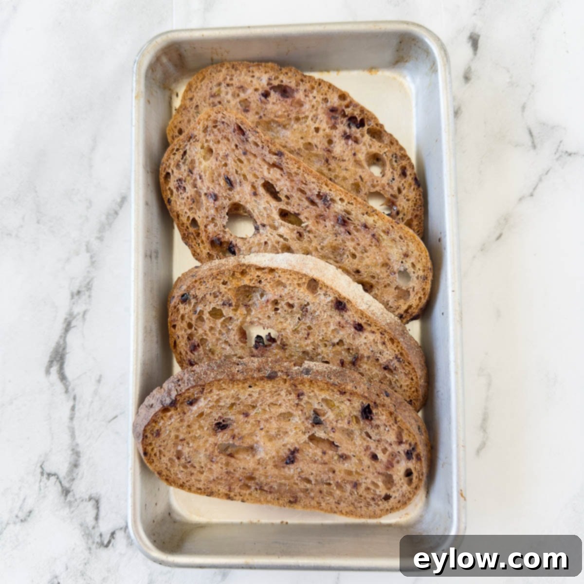 Vibrant Tomato Avocado Toast 4 A silver tray of sliced artisan bread, perfectly toasted.