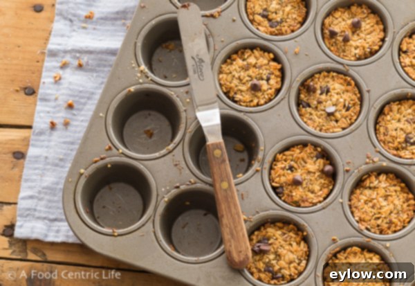 Close-up of freshly baked chocolate chip granola bites on a cooling rack.