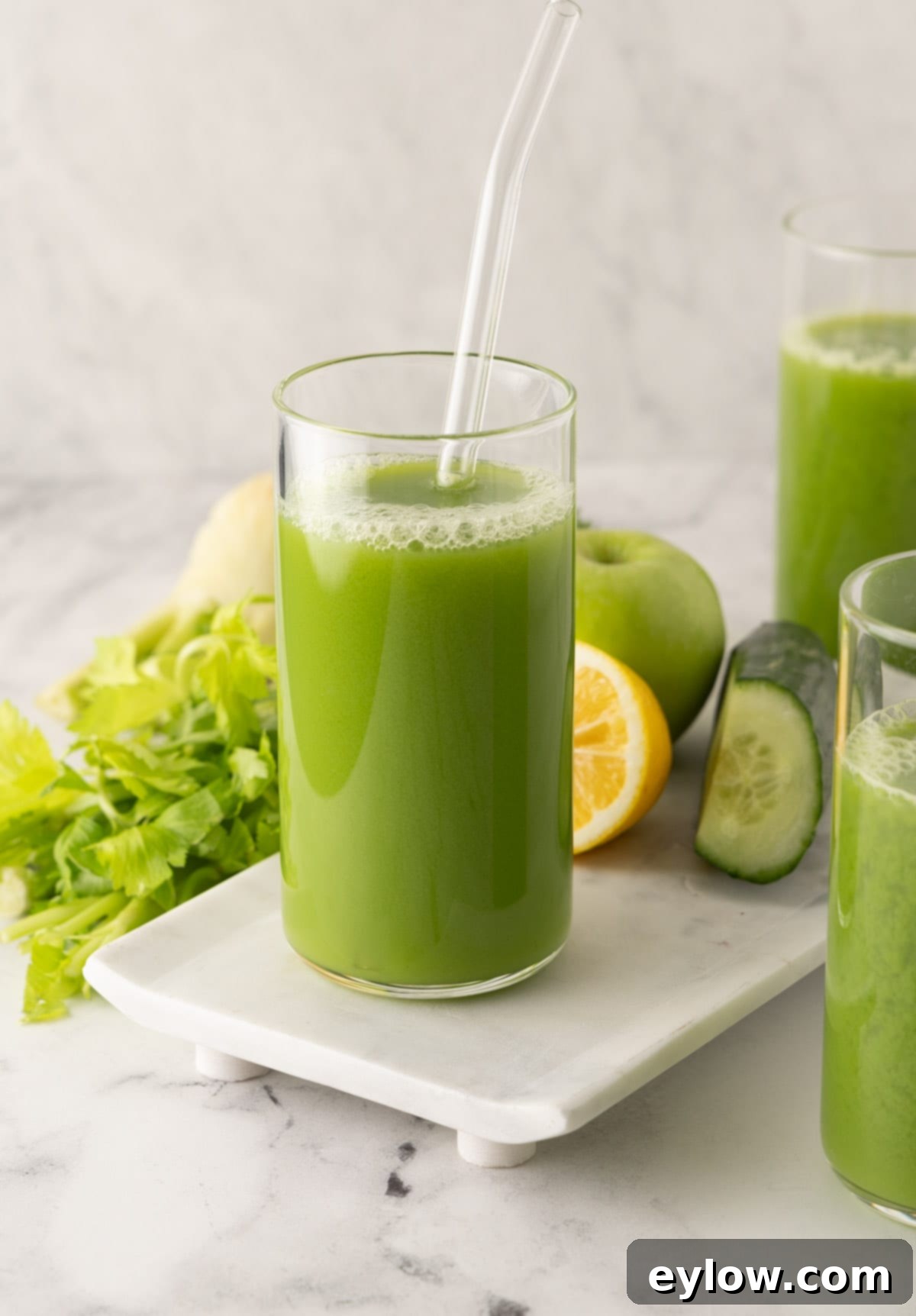 Crisp Green Elixir 2 A vibrant green juices in glass with with cucumber, lemon and celery.