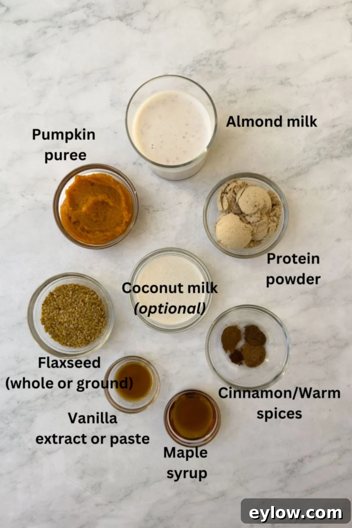 Wholesome Pumpkin Fix in Minutes 3 Ingredients for a pumpkin smoothie on a marble counter.
