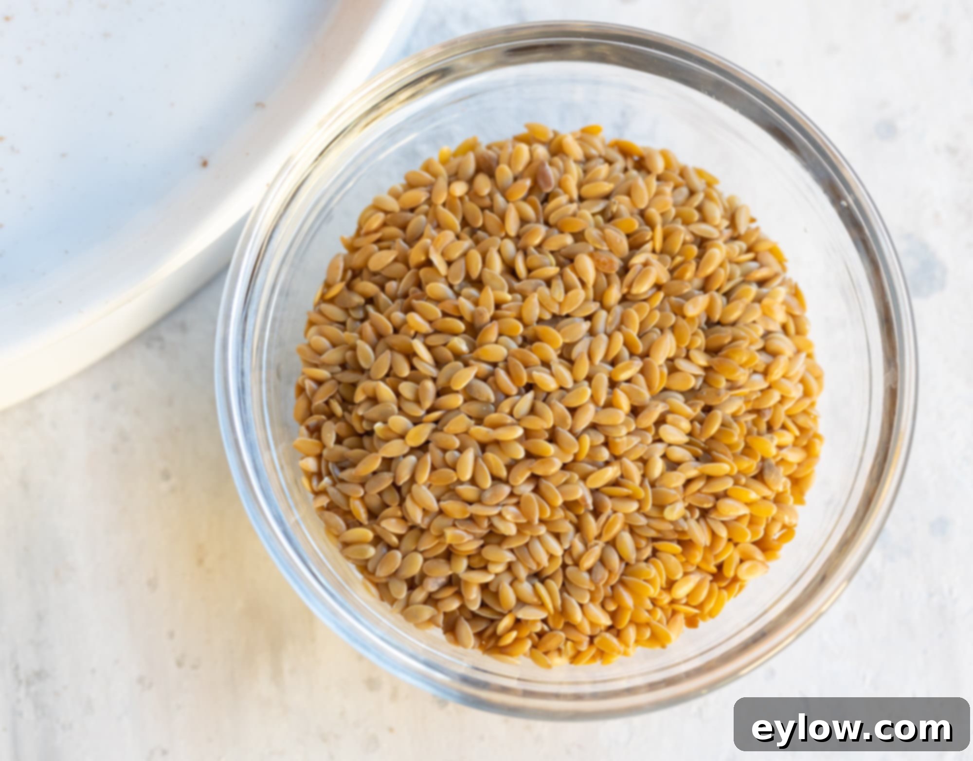 Wholesome Pumpkin Fix in Minutes 4 A small glass bowl of whole golden flaxseed before grinding.