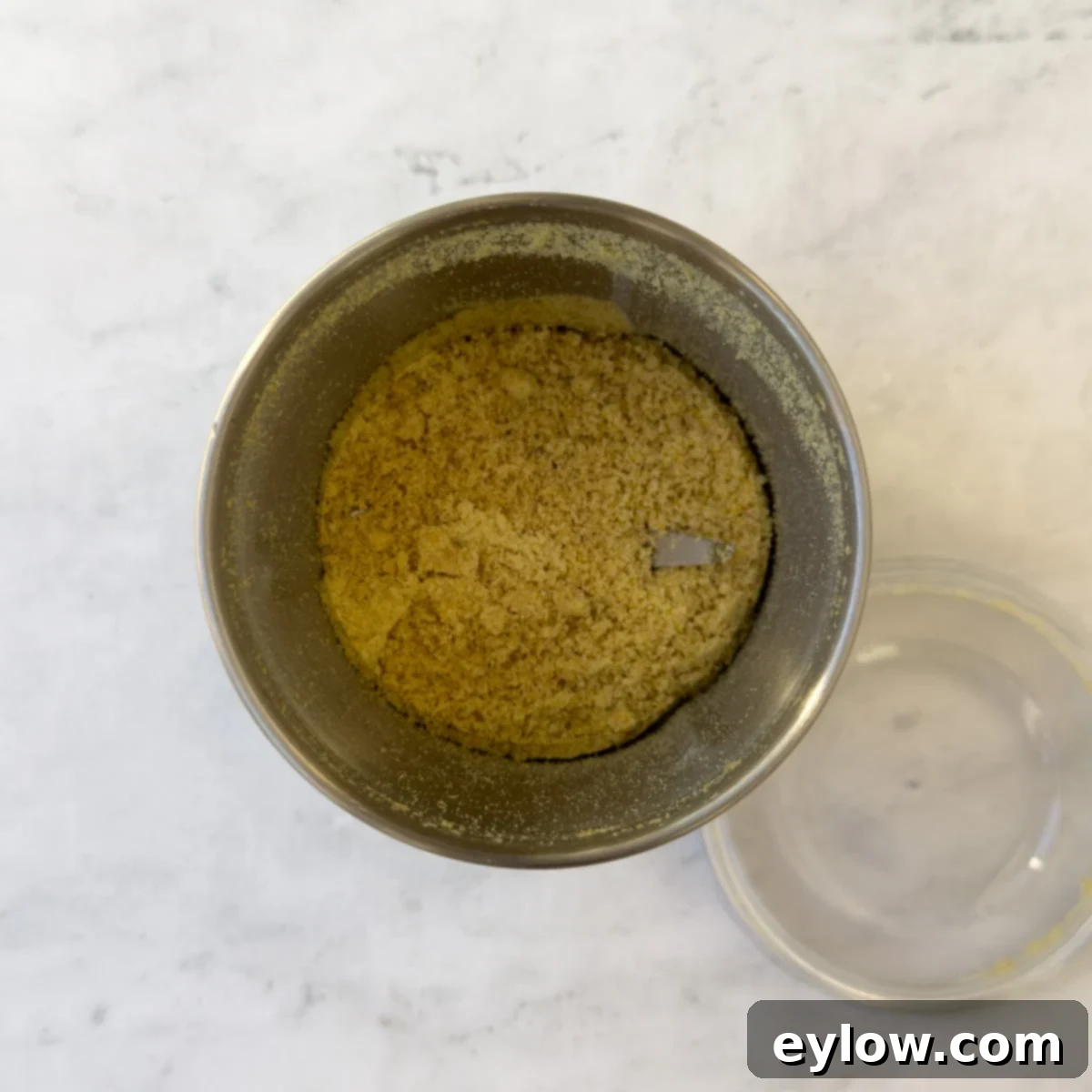 Wholesome Pumpkin Fix in Minutes 5 Golden ground flaxseed in a small hand-held grinder container.