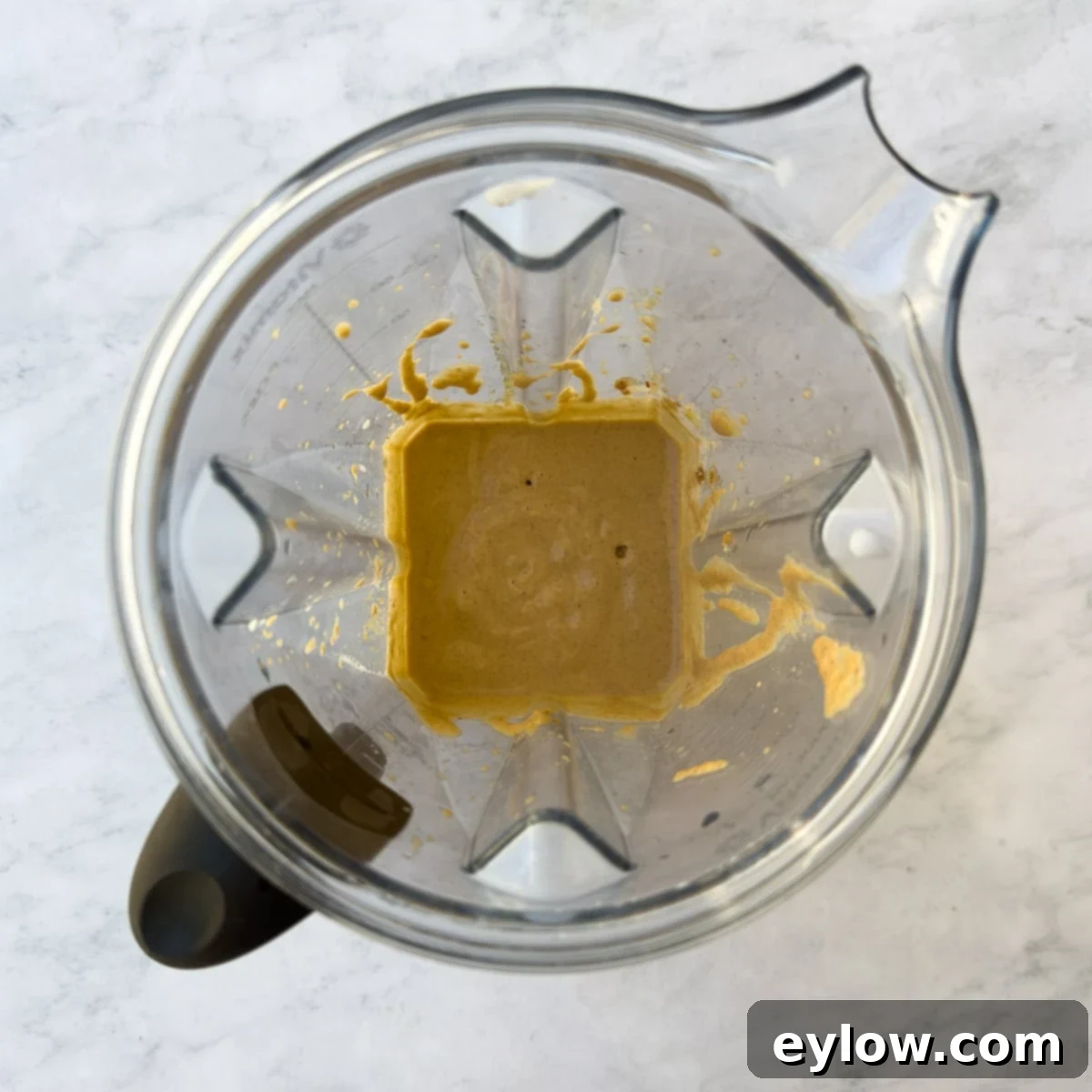 Wholesome Pumpkin Fix in Minutes 6 Creamy orange pumpkin smoothie in a blender container.