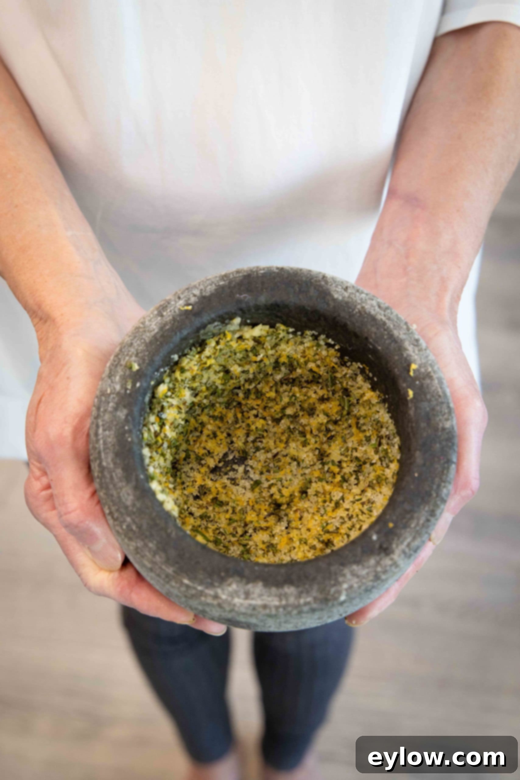 A bowl filled with the prepared dry brine rub, showcasing its finely ground texture and fresh aromatic ingredients, ready for application on the turkey.