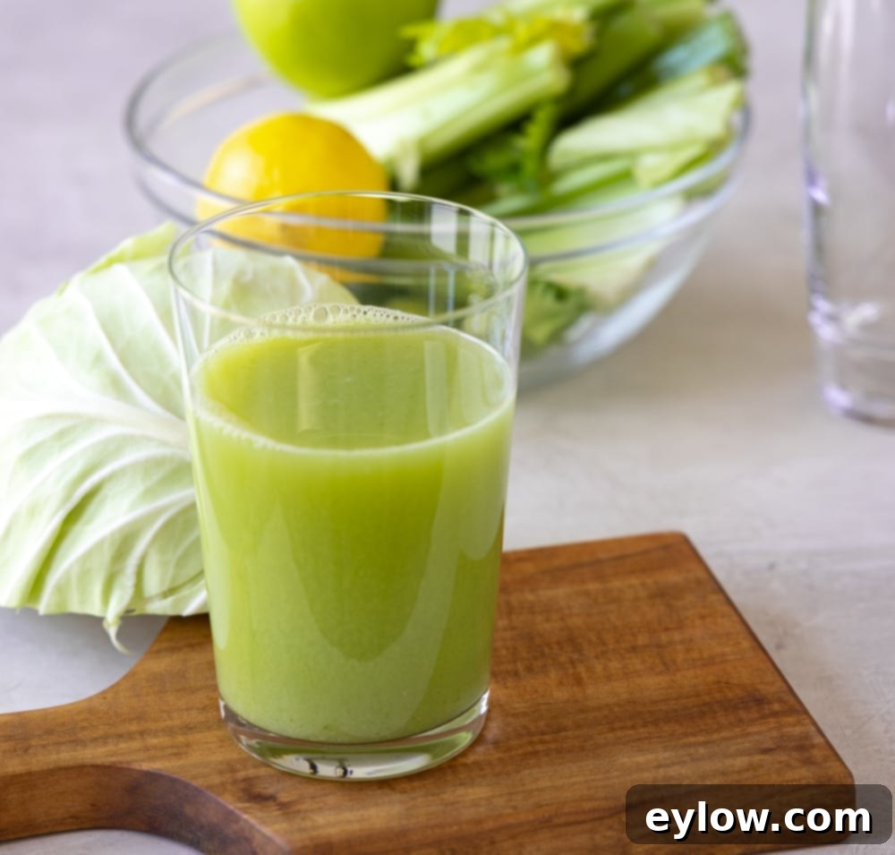 Cabbage Celery Green Elixir 4 Three glasses of vibrant green cabbage and celery juice, garnished with fresh mint, with whole ingredients scattered around. This image conveys freshness, health, and an appealing presentation for a detoxifying and nutritious beverage.
