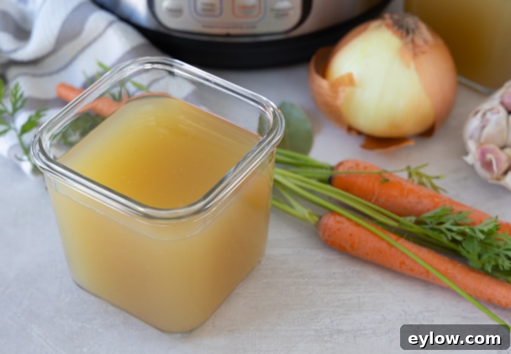 Finished broth in a glass container for freezing.