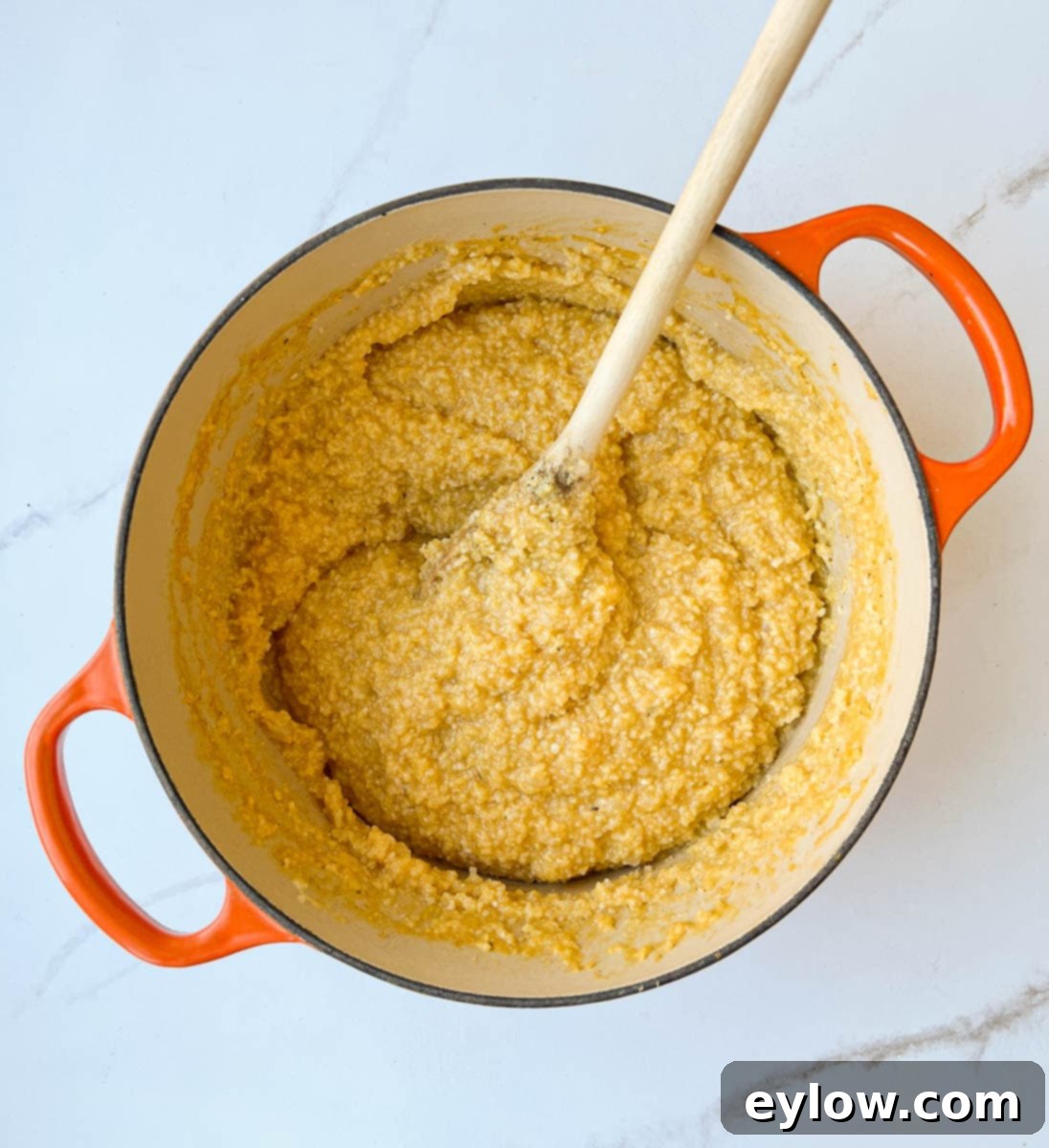 Golden Cheesy Polenta with Poached Eggs 4 Creamy cooked polenta in a pot, ready to be served.