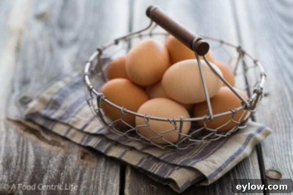 Golden Cheesy Polenta with Poached Eggs 5 A wire basket filled with fresh brown eggs.