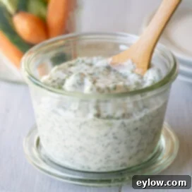 Effortless Green Goddess Dip and Dressing 8 Green goddess dip and dressing in a jar with a wooden spoon for serving.