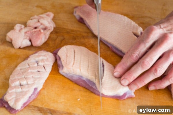 Technique: Scoring duck breast fat into a cross-hatch pattern for efficient rendering.