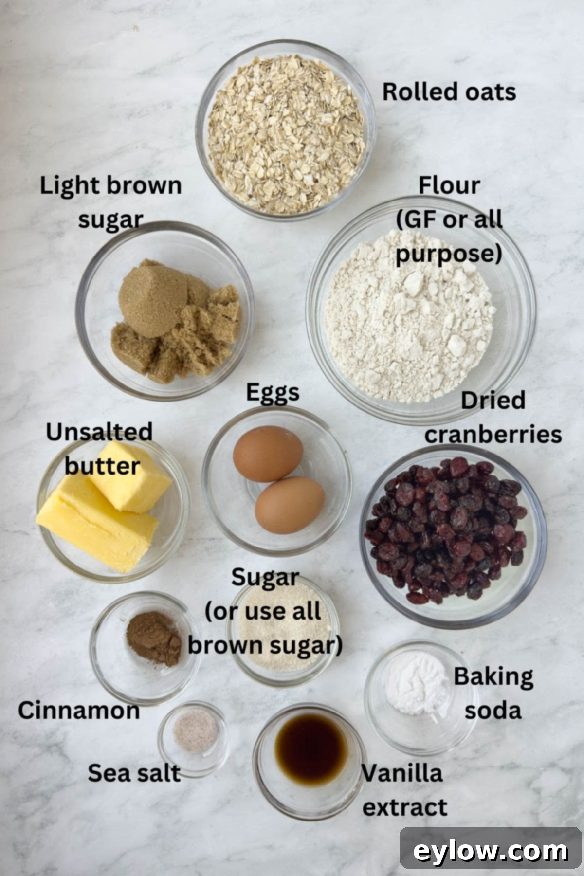 Homemade Cranberry Oatmeal Cookie Bliss 3 Ingredients to make cranberry oatmeal cookies in prep bowls on a marble counter.