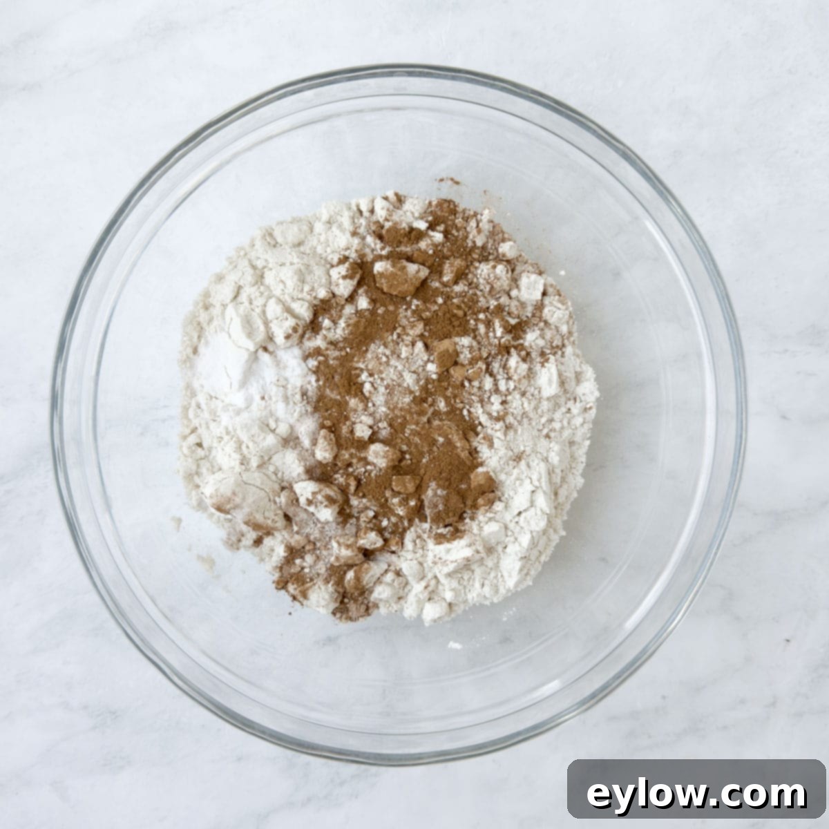 Homemade Cranberry Oatmeal Cookie Bliss 4 Cinnamon and flour in a glass bowl, dry ingredients for cookies.