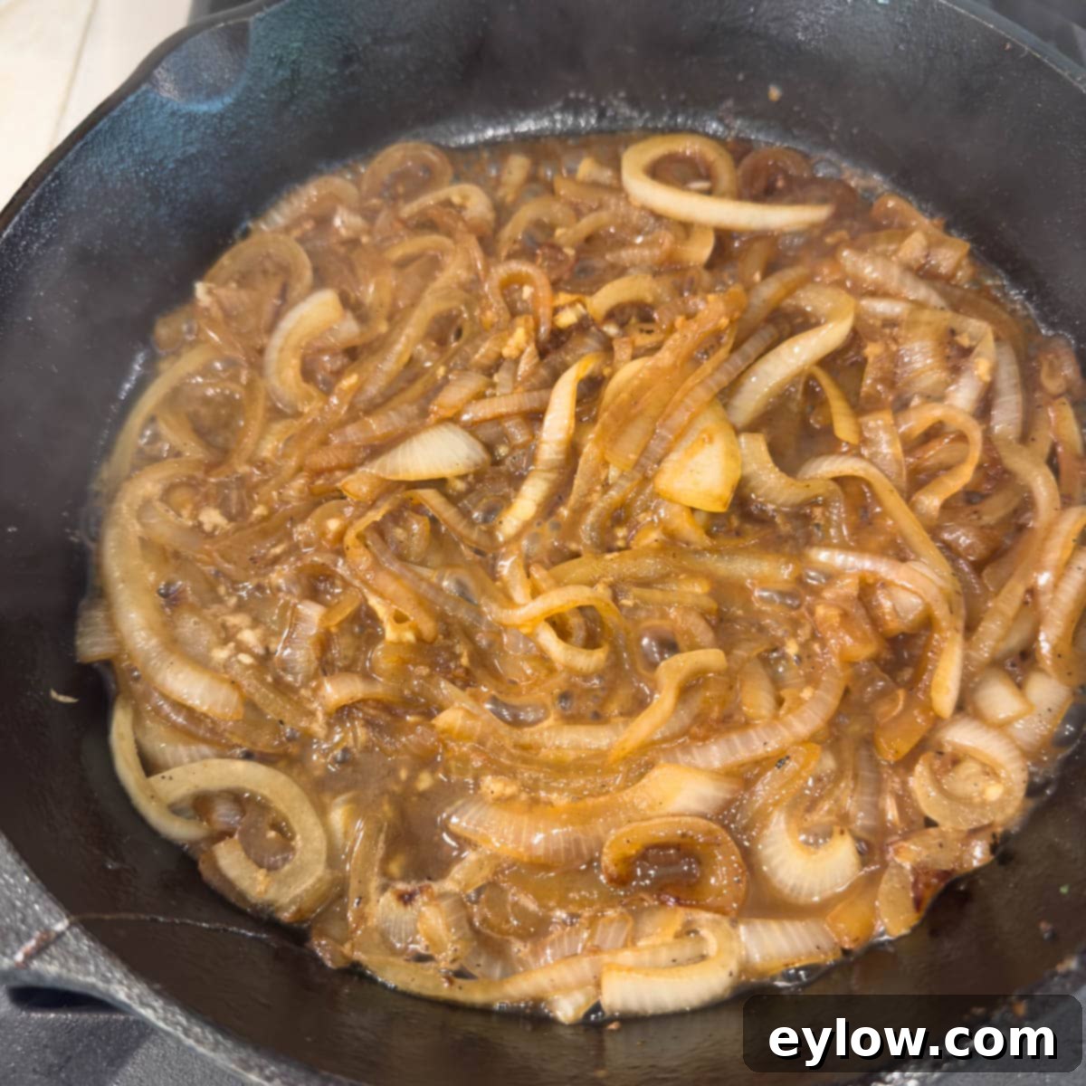 Creamy Sour Cream Pork Chops 8 Deglazing a cast iron skillet with dry white wine after caramelizing onions.