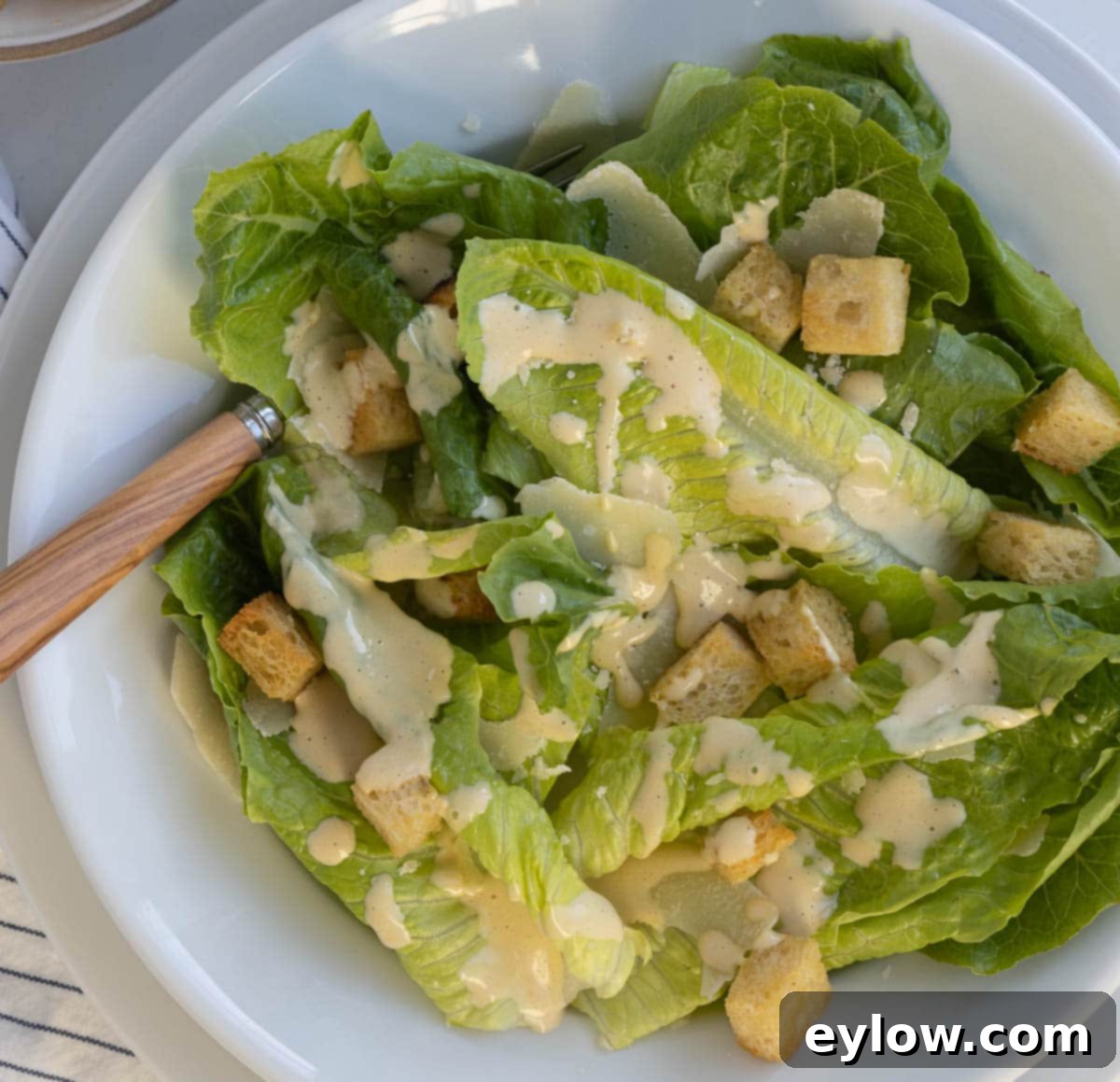 Caesar Dressing No Anchovies Needed 7 A close-up of a vibrant Caesar salad with fresh romaine lettuce leaves and crisp croutons.