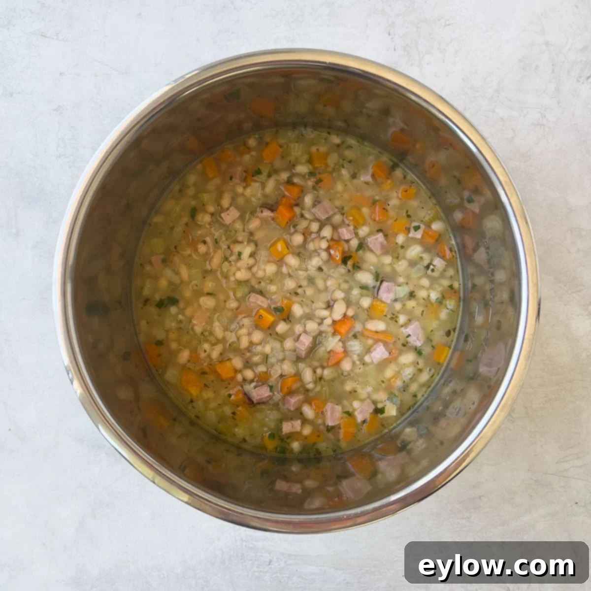 Cooked navy bean soup in the Instant Pot after quick release of pressure, ready to be served.