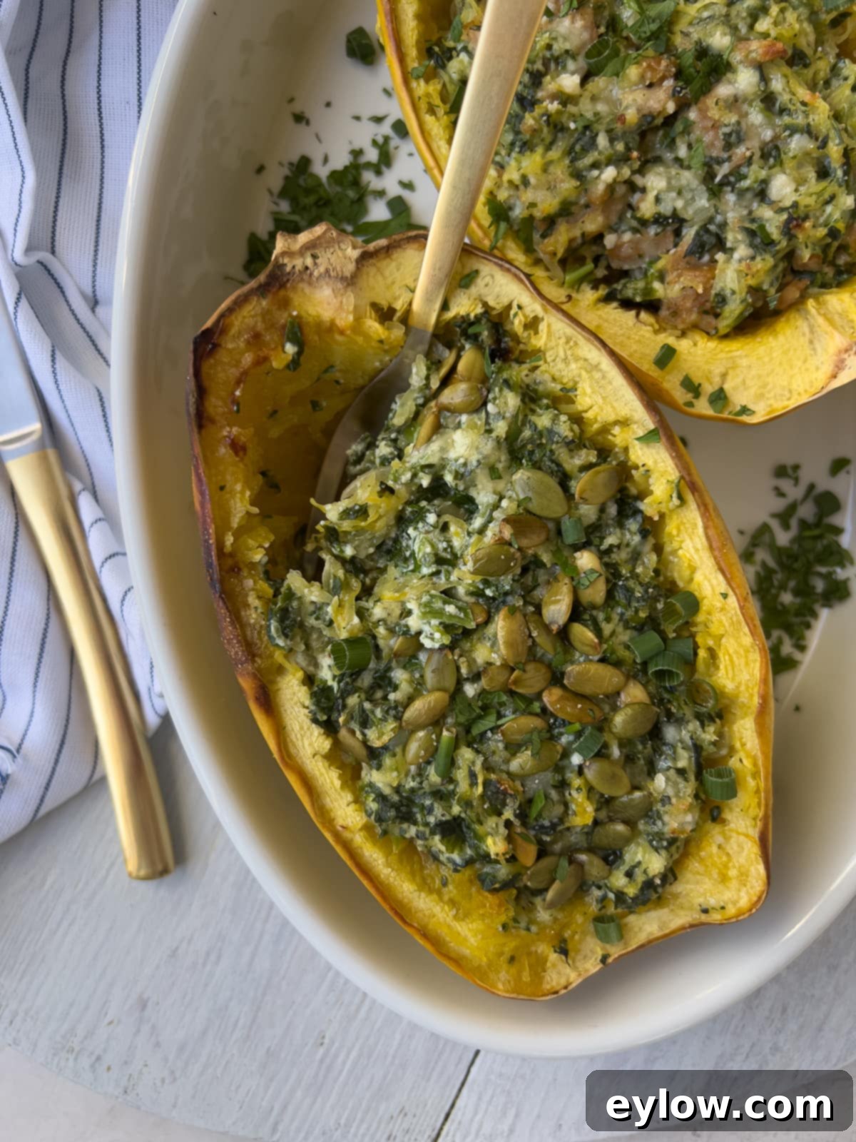 Baked spaghetti squash halves generously stuffed with the creamy ricotta and spinach filling, ready to serve.